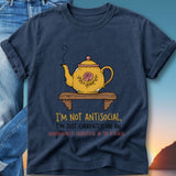 Navy t-shirt with yellow teapot graphic and text "I'M NOT ANTISOCIAL, I'M JUST CURRENTLY ON AN UNANNOUNCED SABBATICAL IN THE KITCHEN".