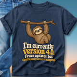 Navy t-shirt with a sloth hanging from a branch and text "I'm currently version 4.0. Fewer updates, but significantly better at napping."