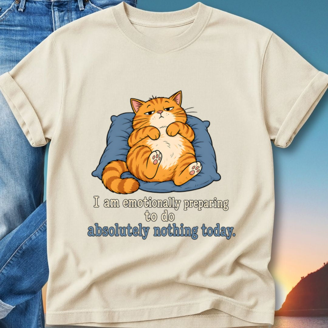 Cream t-shirt with cat resting on pillow, text "I am emotionally preparing to do absolutely nothing today."