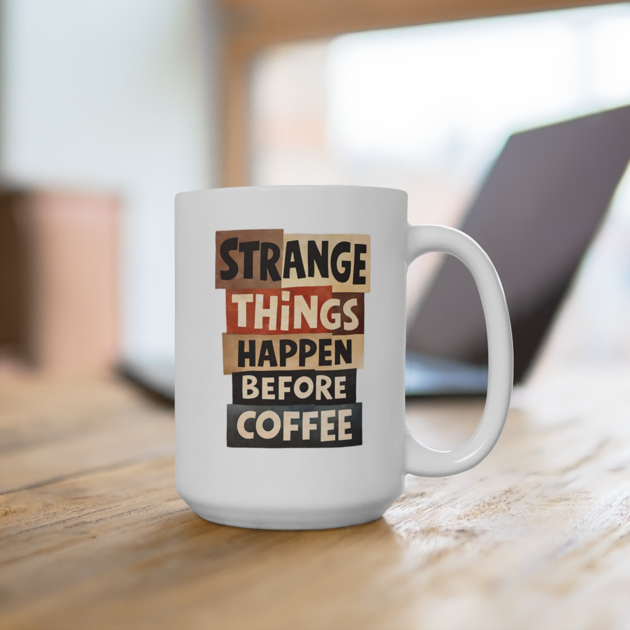 White mug with "Strange Things Happen Before Coffee" text in cut-out letters.