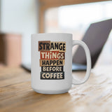 White mug with "Strange Things Happen Before Coffee" text in cut-out letters.