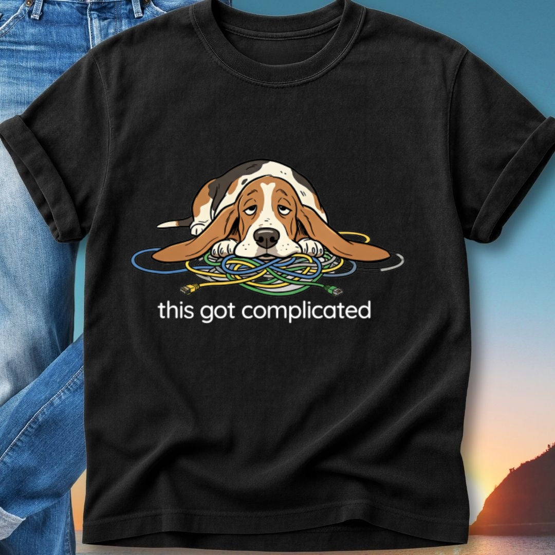 Basset hound tangled in wires with "this got complicated" text.
