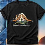 Basset hound tangled in wires with "this got complicated" text.
